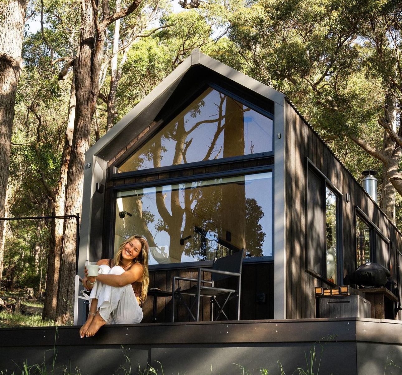 Modern glamping pods nestled among trees offering private outdoor accommodations.