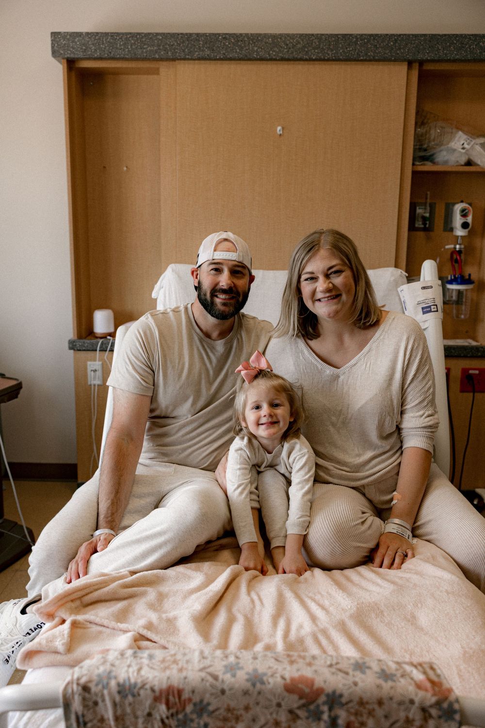A heartwarming sequence of candid family moments on a bed with neutral tones and soft lighting.