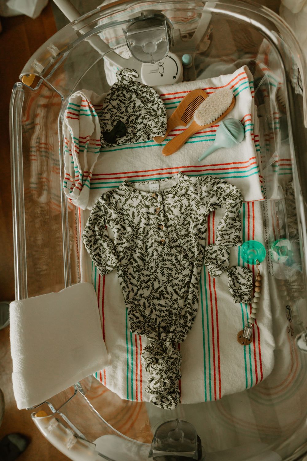 Artistic overhead view of vintage ceramic tray with gray roped pattern against striped retro fabric in teal and red.