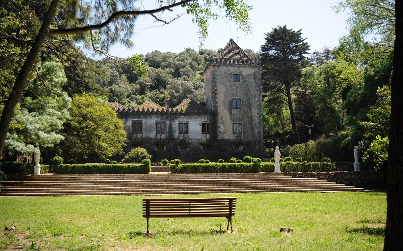 Panoramic view of a grand estate with manicured lawns and historic architecture.