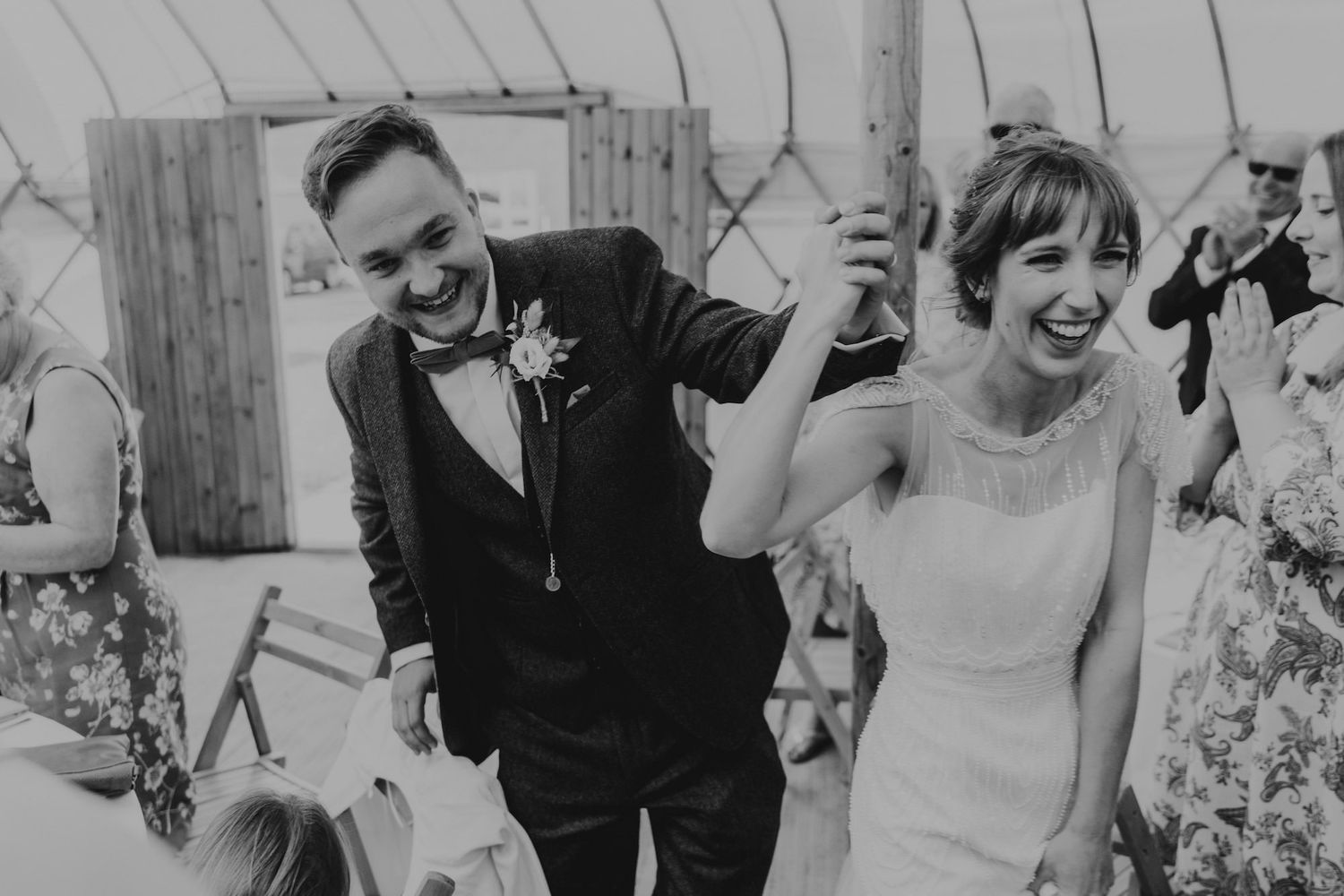 A joyful black and white moment captured during a wedding celebration.