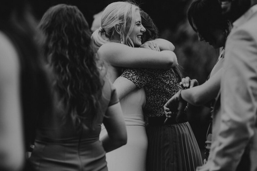Dark silhouettes of wedding guests dancing at an evening reception.