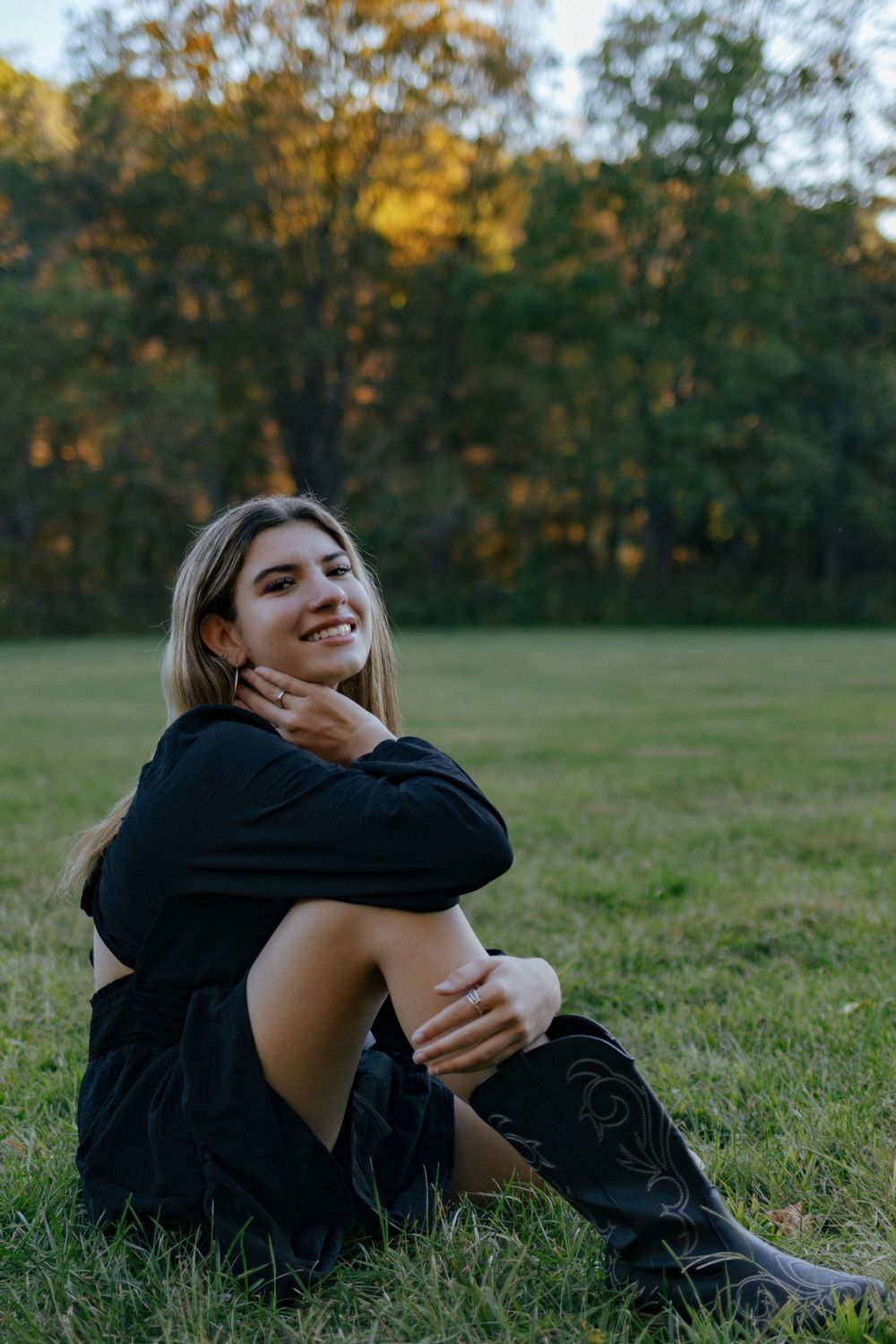 Someone lies casually on green grass while enjoying a warm autumn evening.