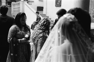 A young boy watches guests mingle in the grand hall of Cuneo Mansion before the wedding.