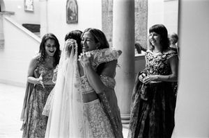 A film photo of a bride hugging wedding guests before wedding ceremony at Cuneo Mansion.