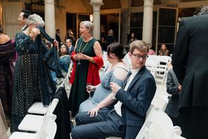 Guests sip champagne before the wedding ceremony in the grand hall of Cuneo Mansion.