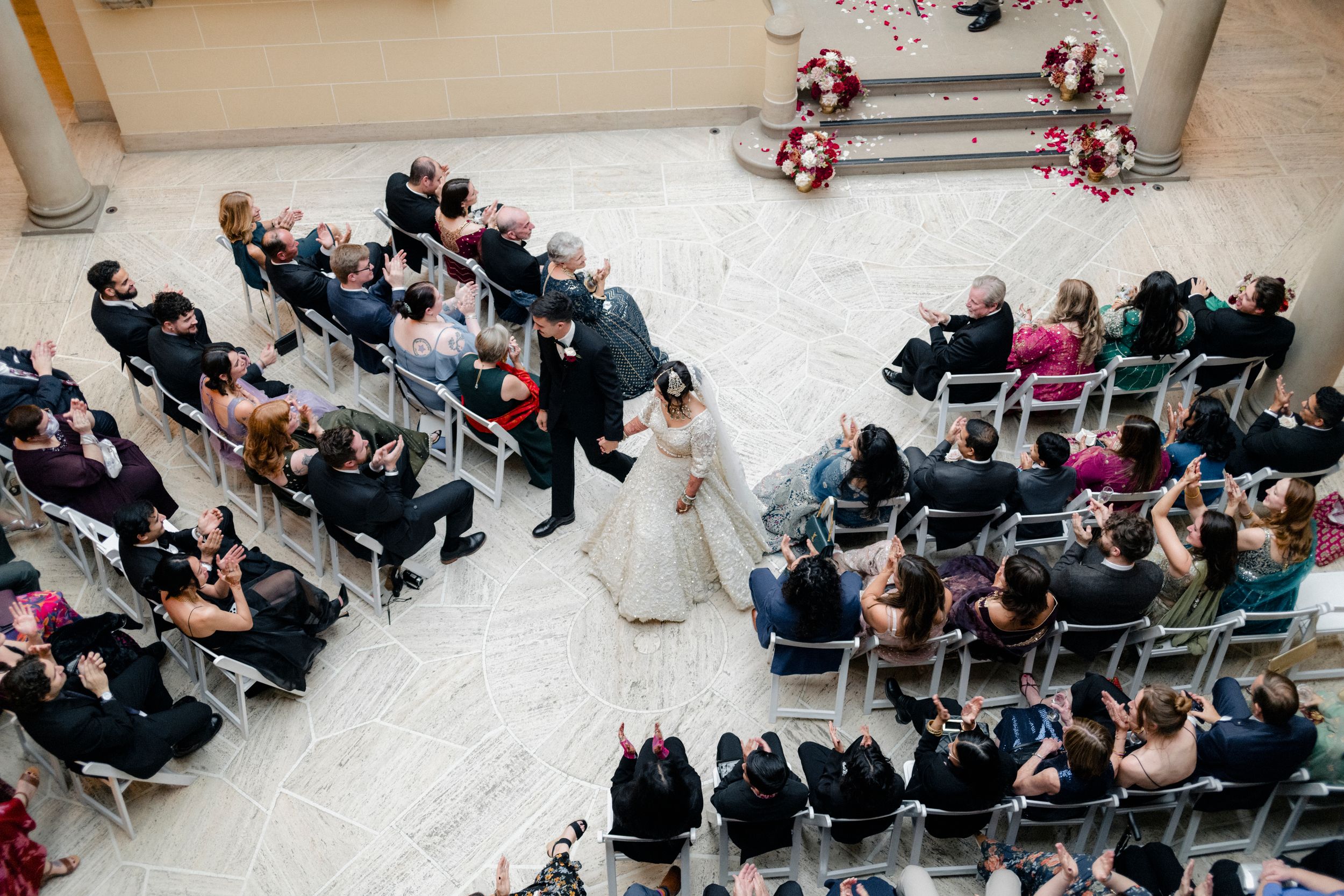 A bride and groom process out of the wedding ceremony at Cuneo Mansion.
