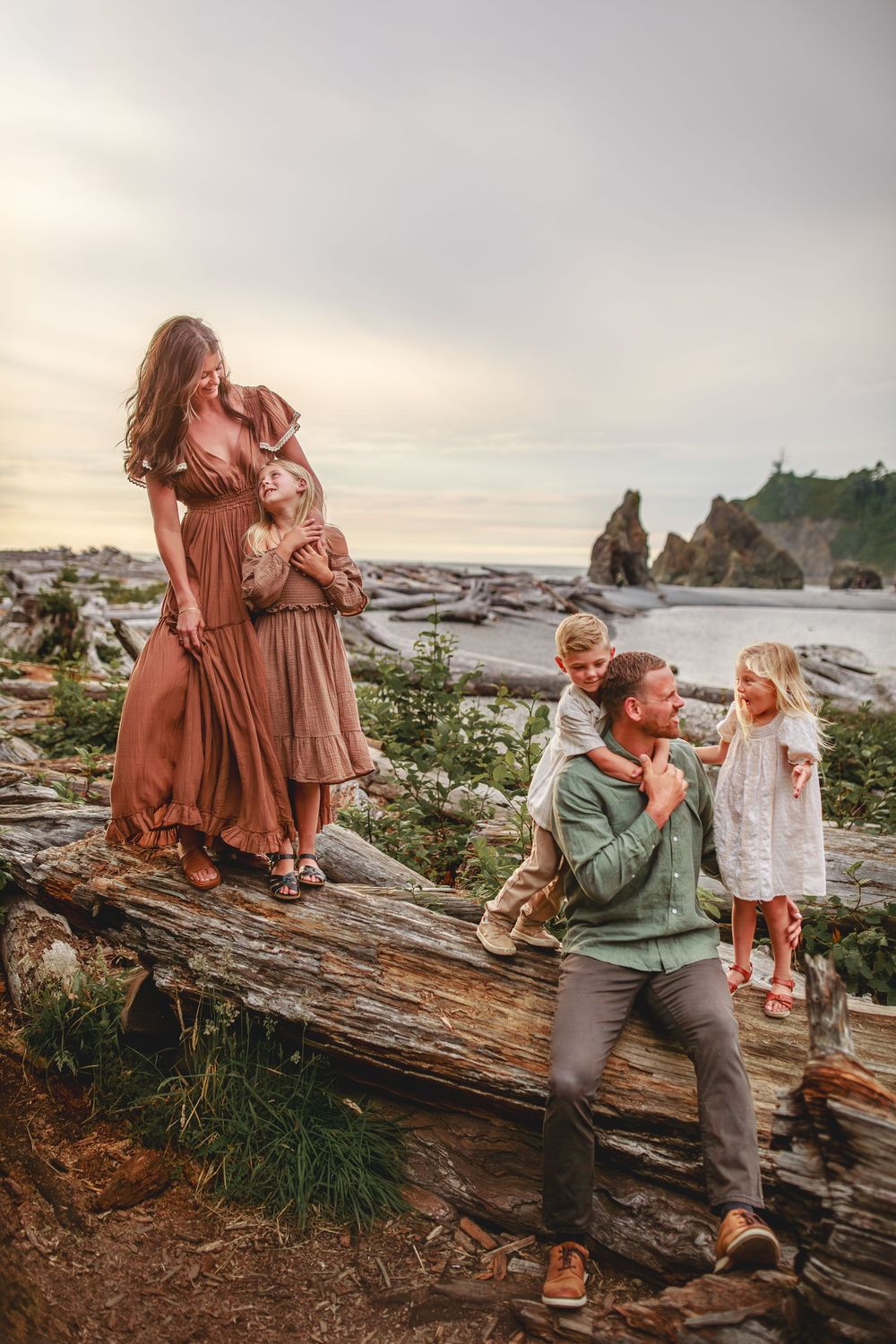 Family snuggling together during their family adventure photography session at Ruby Beach in Olympic National Park near Seattle, Washington