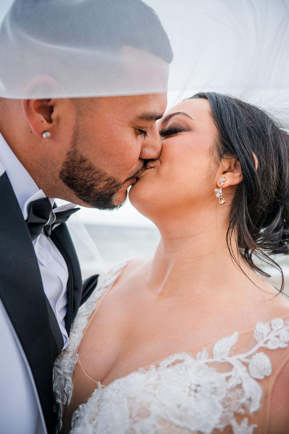 Close-up shots of a romantic wedding kiss sequence with delicate lace details visible on the dress.