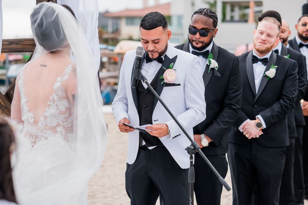 Wedding party members sharing emotional moments during formal outdoor portraits.