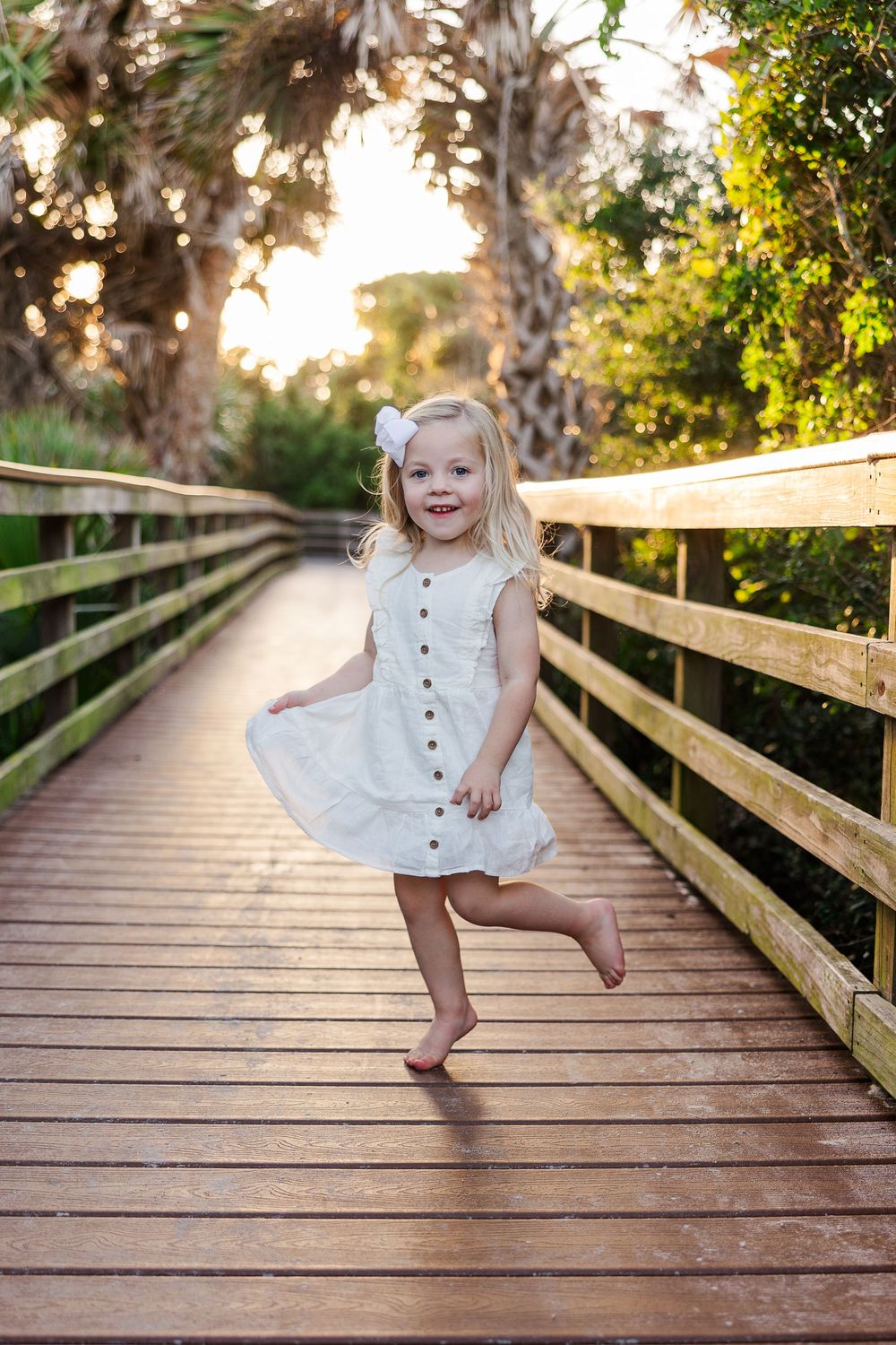 A sequence of playful dance moves captured on a wooden boardwalk with palm trees and golden sunlight.
