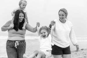 Candid black and white photos showing playful moments on the beach.