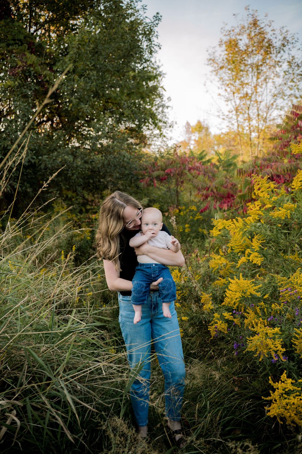 Intimate family portraits captured against a backdrop of vibrant autumn wildflowers and natural foliage.