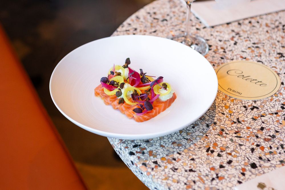 Colorful plated dishes on a speckled granite countertop in an upscale restaurant setting.