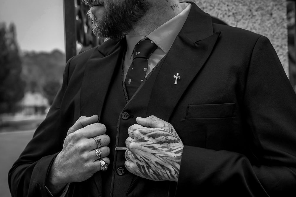 A black and white photo series showing hands holding playing cards in a sequence of card game moves.