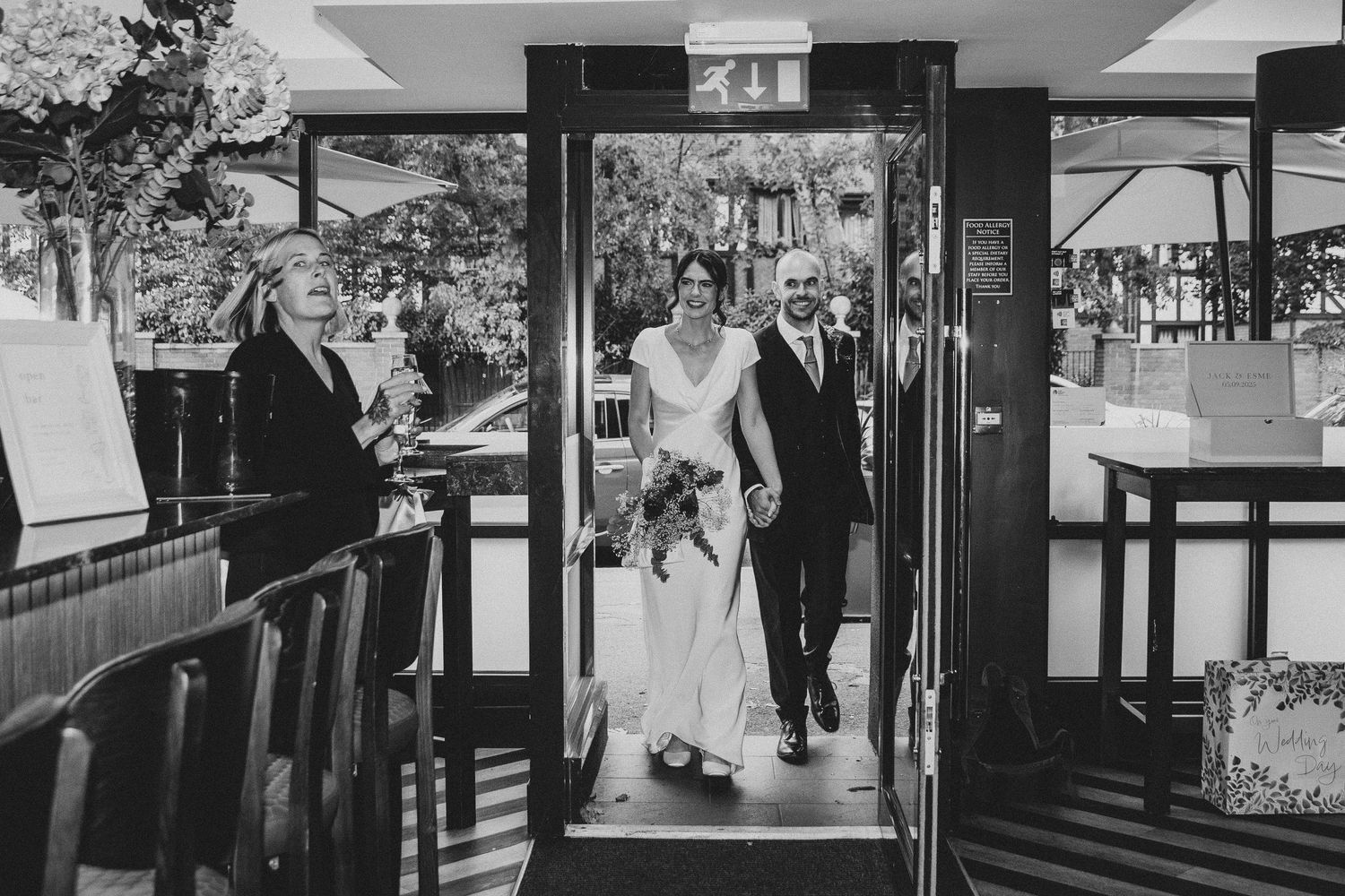 Black and white wedding photographs showing couples in various romantic moments at a venue with elegant decor and lighting.