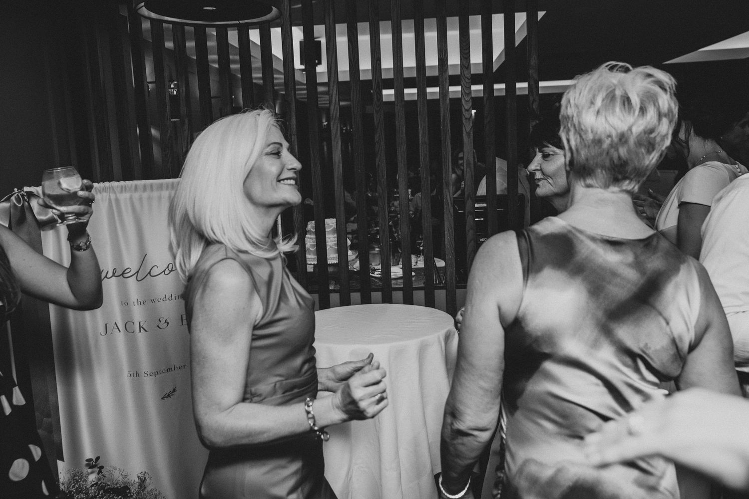 Black and white photo of couples dancing closely together at a wedding reception or party.