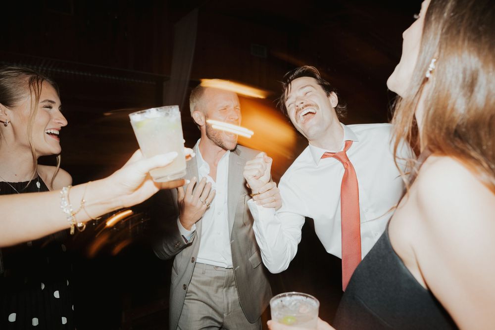 A series of candid dance floor moments at a wedding reception showing guests dancing and celebrating together.