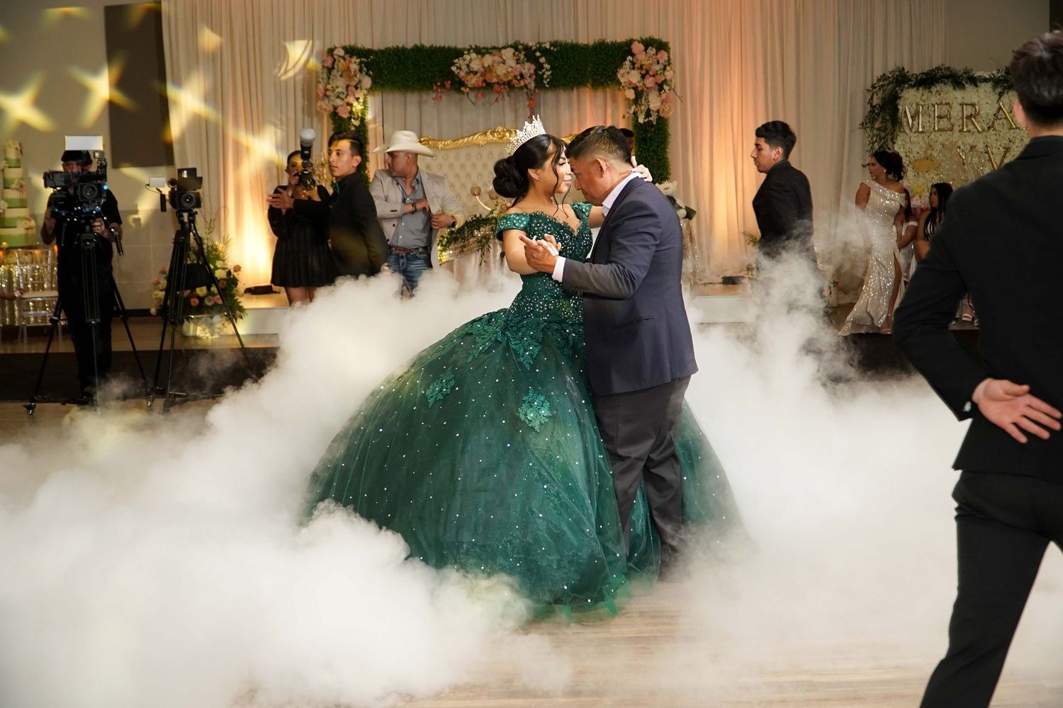 DFW quince venue photographed during live quinceañera celebration, showcasing stage area, dance floor, and décor placement