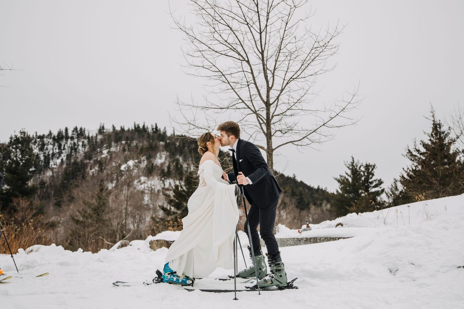 couple having an intimate wedding in the adirondacks on their  skis in the snow