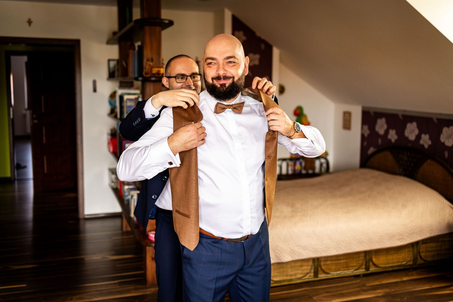 Wedding party members in formal attire sharing emotional moments during preparations.