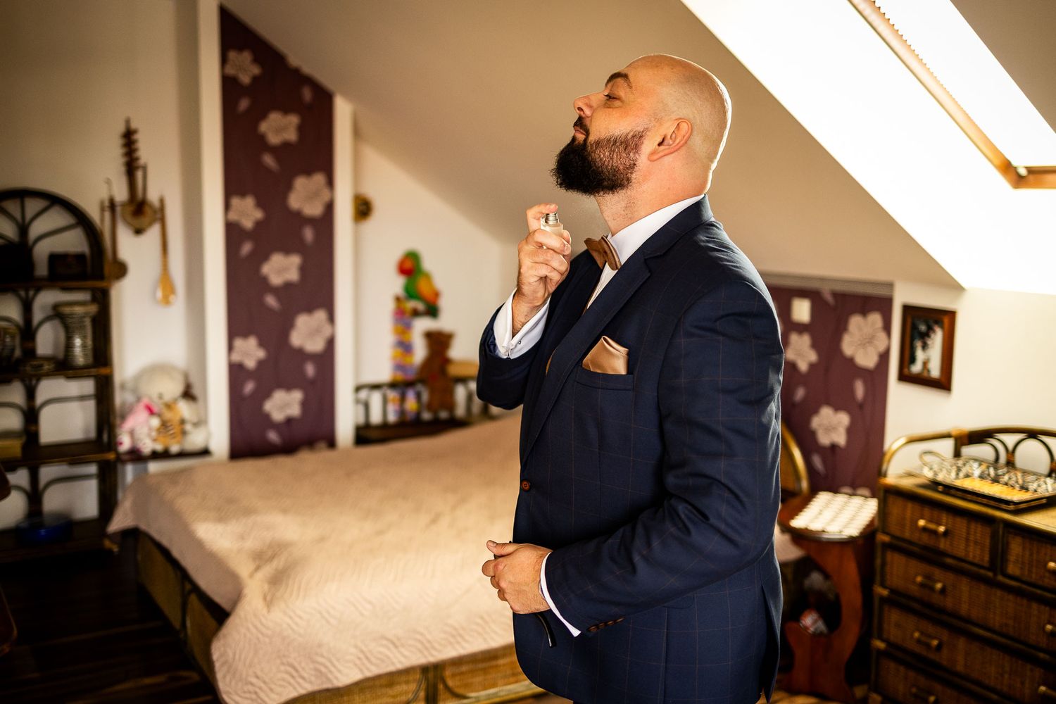 Groomsmen in navy suits and white shirts helping each other with final adjustments.