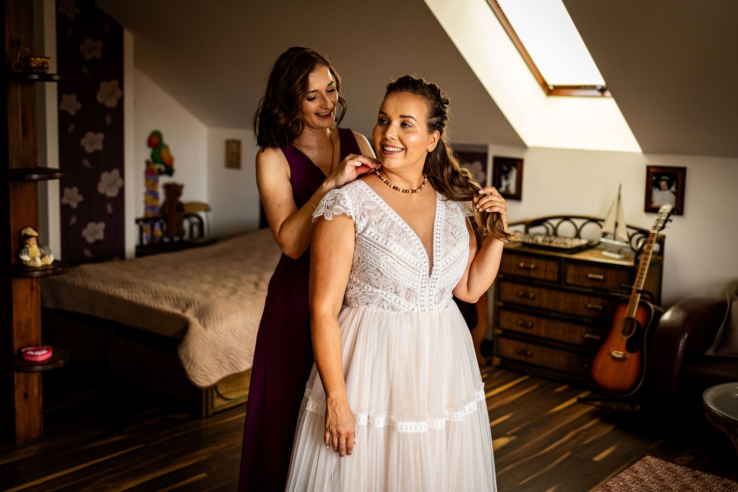 Wedding preparation scene in an attic bedroom with wooden floors and sloped ceiling.