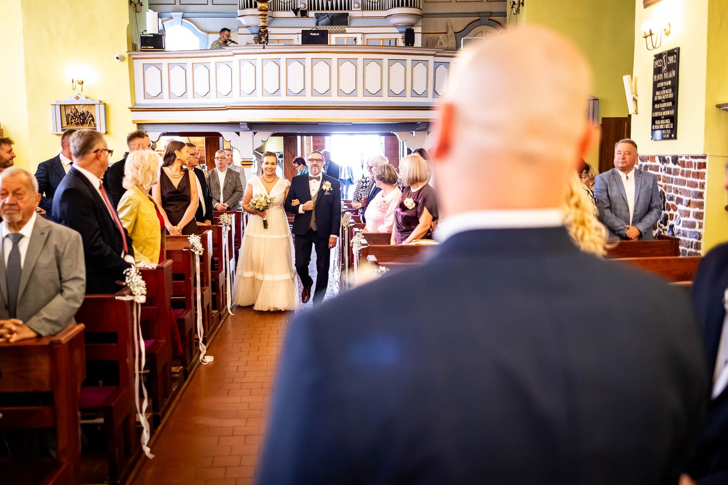Wedding celebration in elegant yellow-walled venue with classic decor.