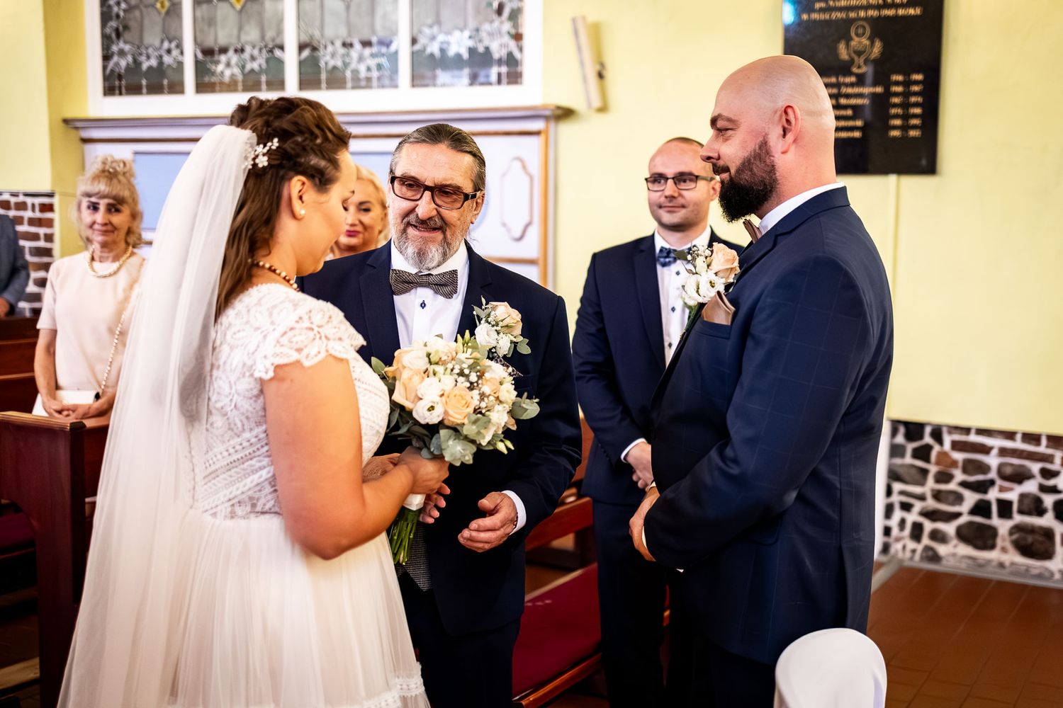 Wedding celebration in bright yellow room with vintage architectural details.