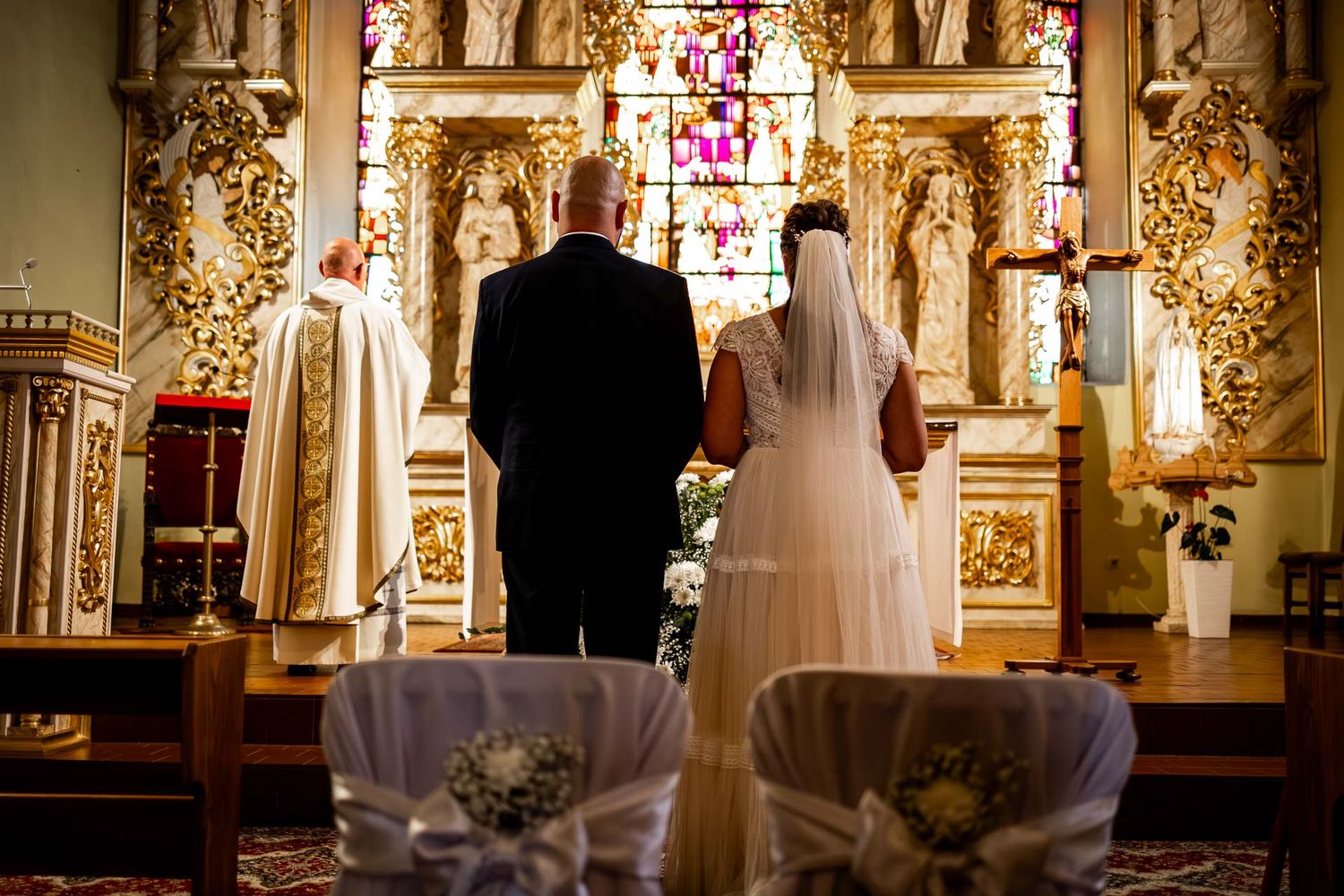 Ornate gold decorative elements adorn the interior of a traditional church sanctuary.