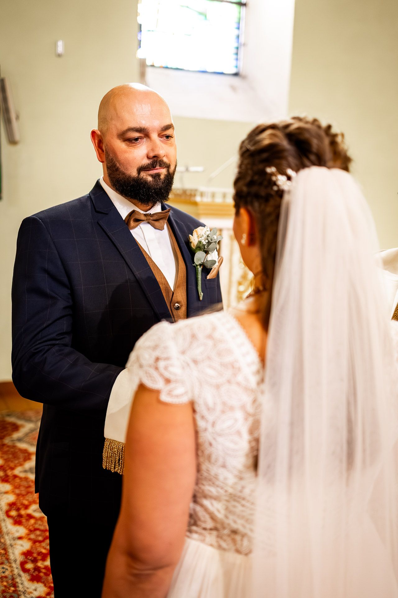 A tender first look moment between newlyweds in a church setting.