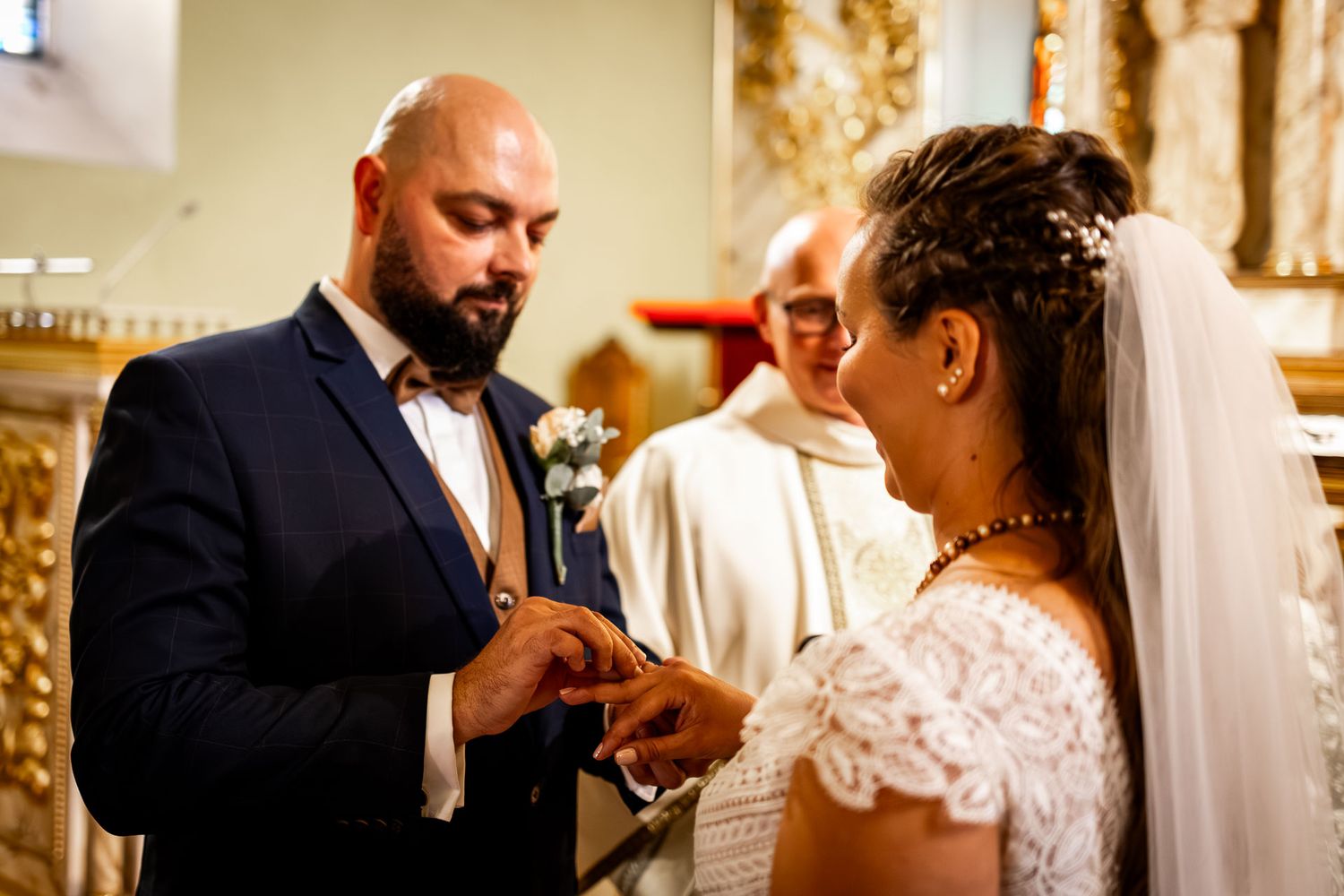 An intimate wedding ceremony moment captured in a traditional church setting.