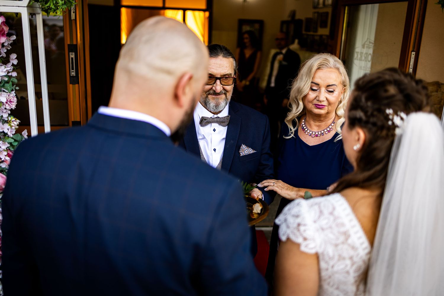 Wedding guests gather around during an intimate ceremony moment.