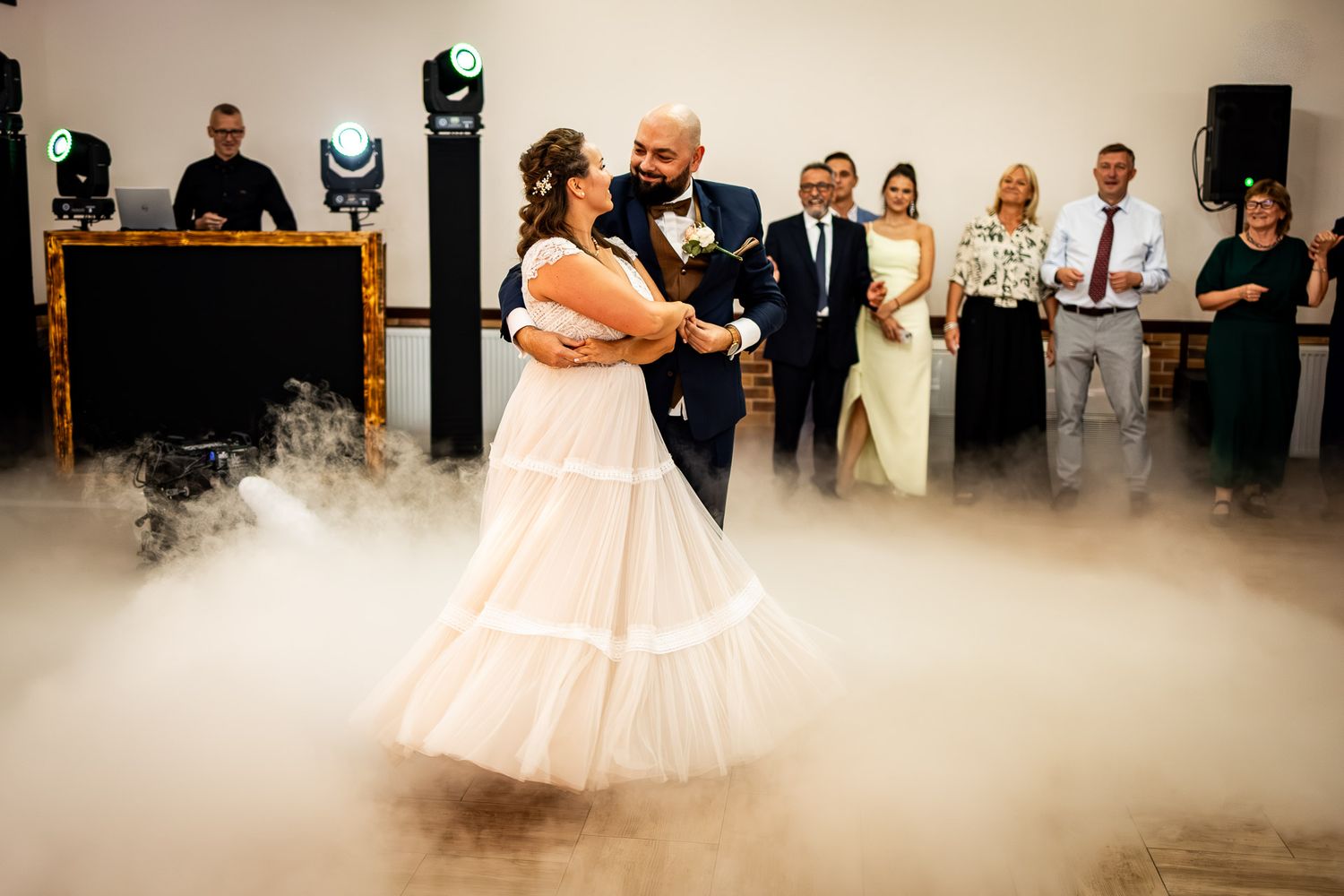Low-lying fog creates a dreamy atmosphere during a wedding first dance.