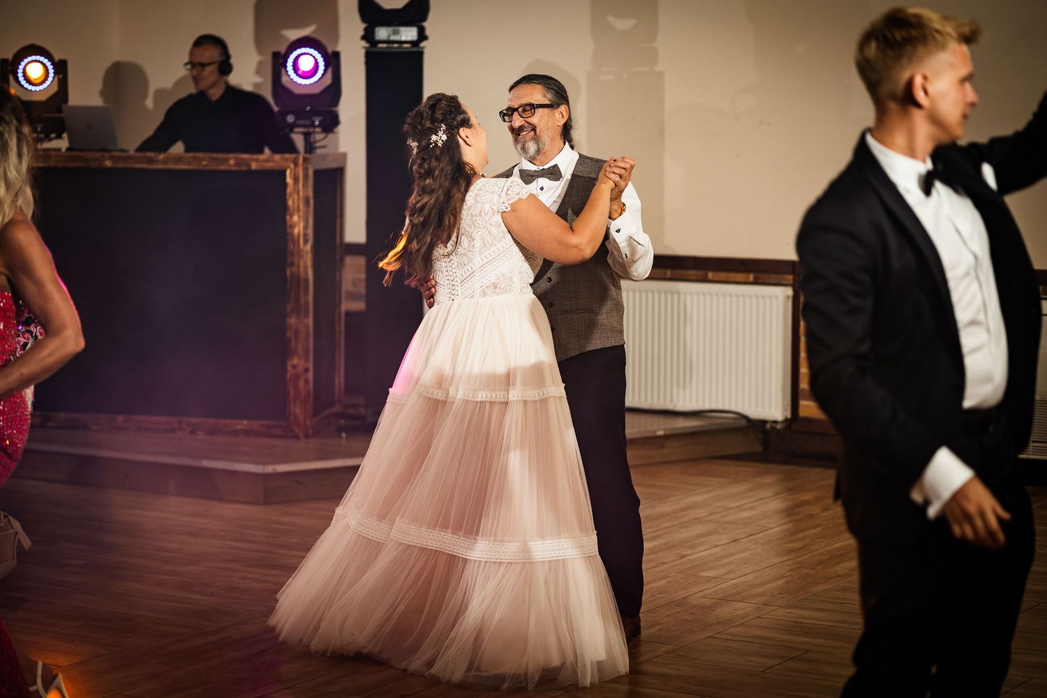 Wedding reception dance floor with dramatic lighting and elegant decor.