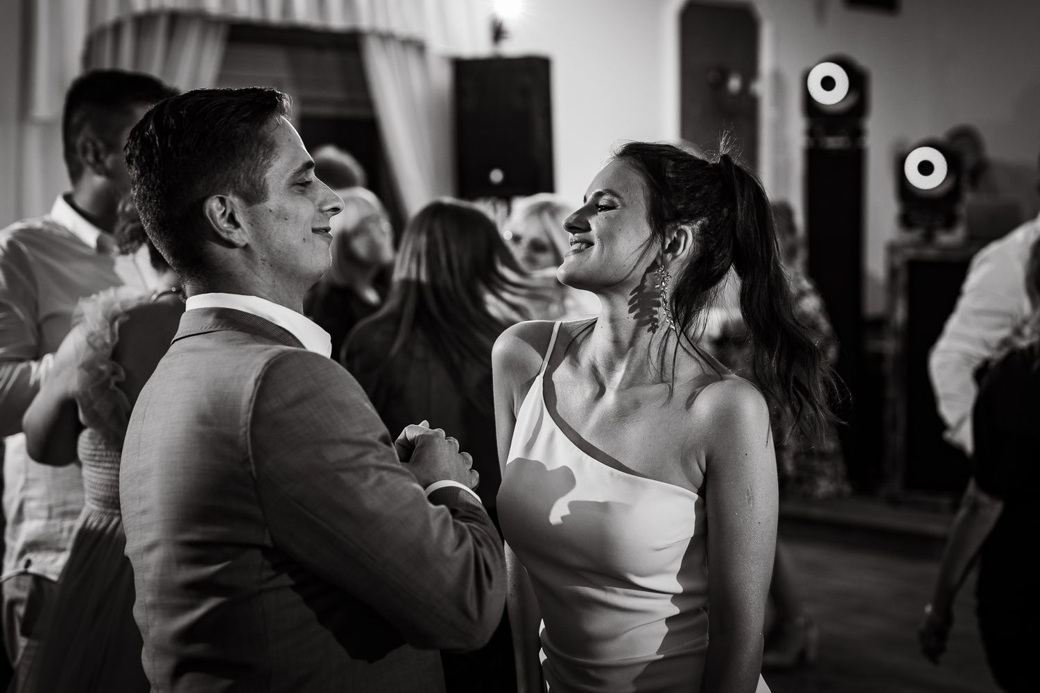 Black and white dance floor scene at an elegant wedding reception.