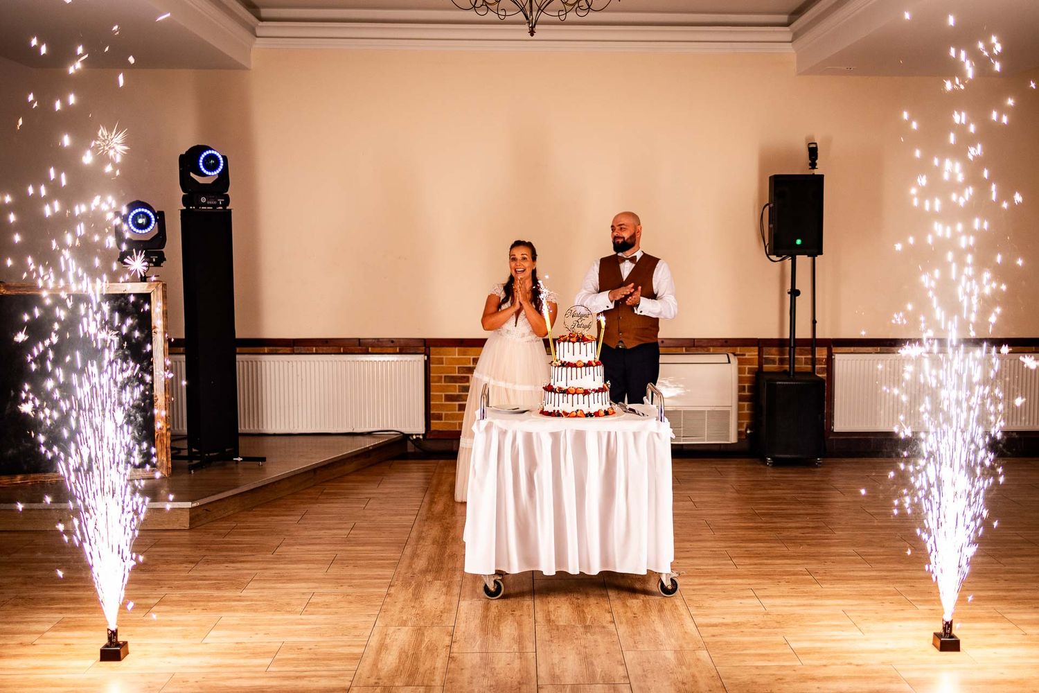 Wedding reception hall with sparkler fountains creating a dramatic entrance effect.