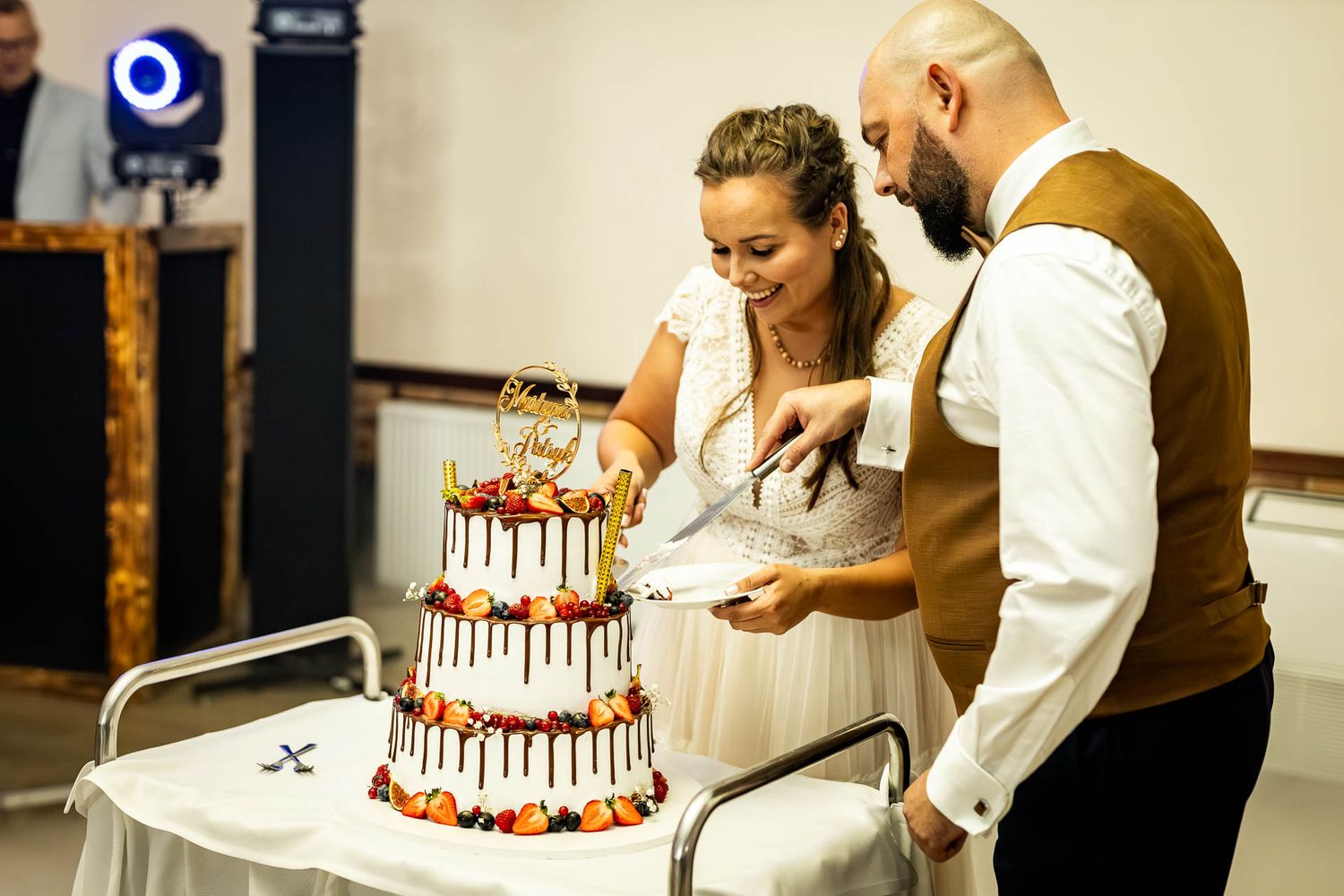 Wedding cake cutting ceremony with a classic tiered white cake.