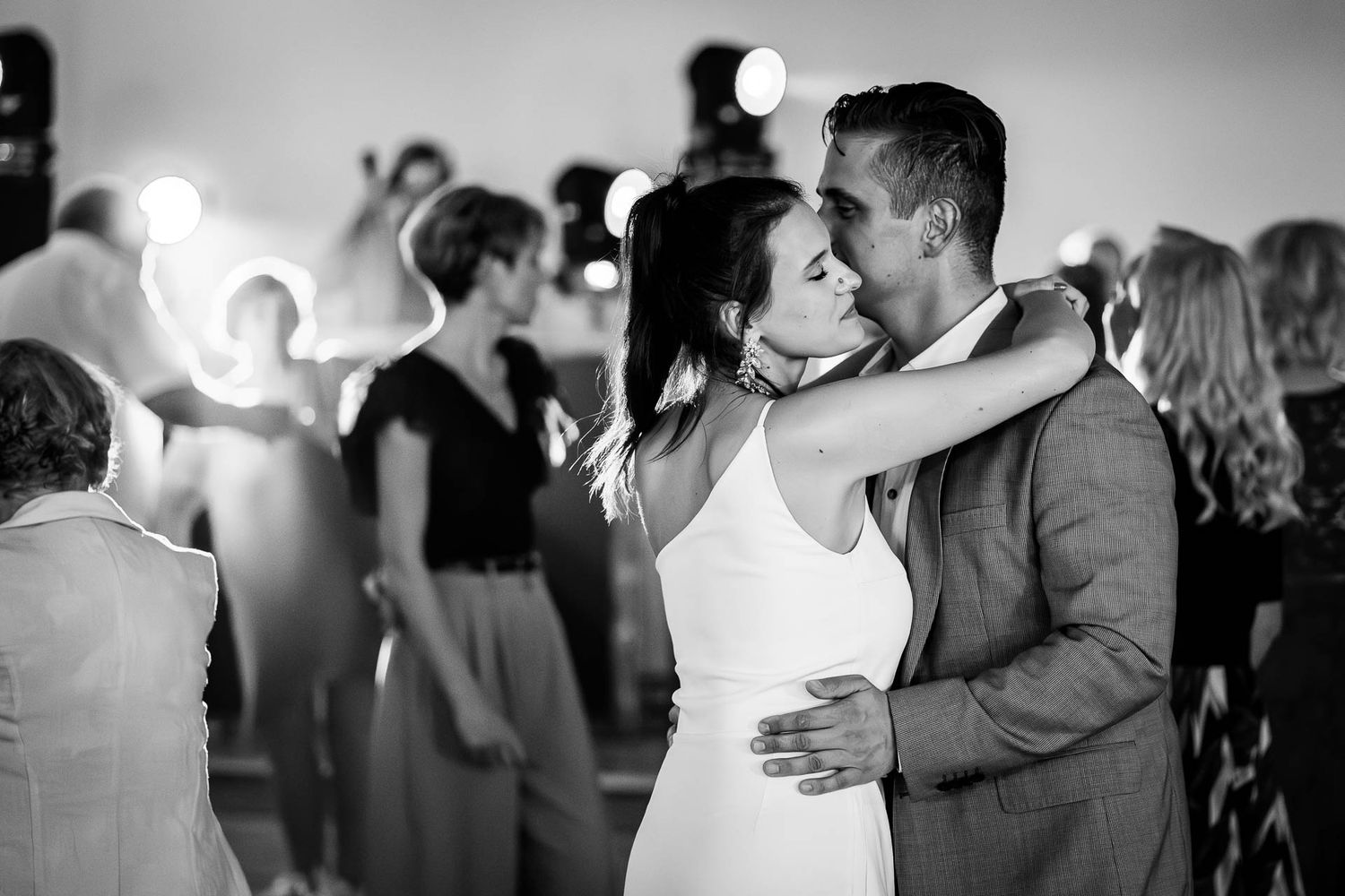 Black and white photos of couples dancing at an elegant wedding reception.