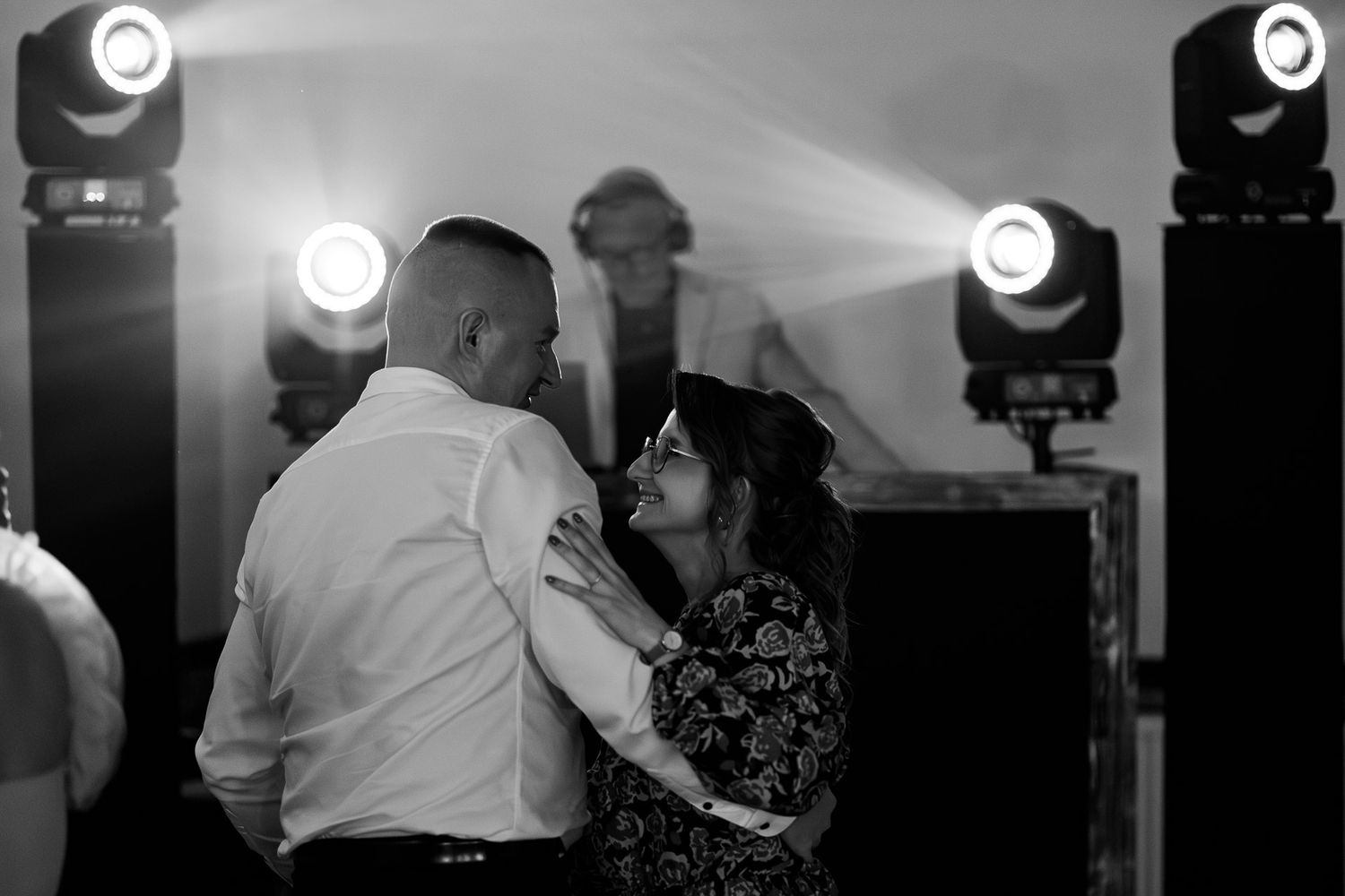 Wedding reception dance floor with dramatic spotlight effects in black and white.