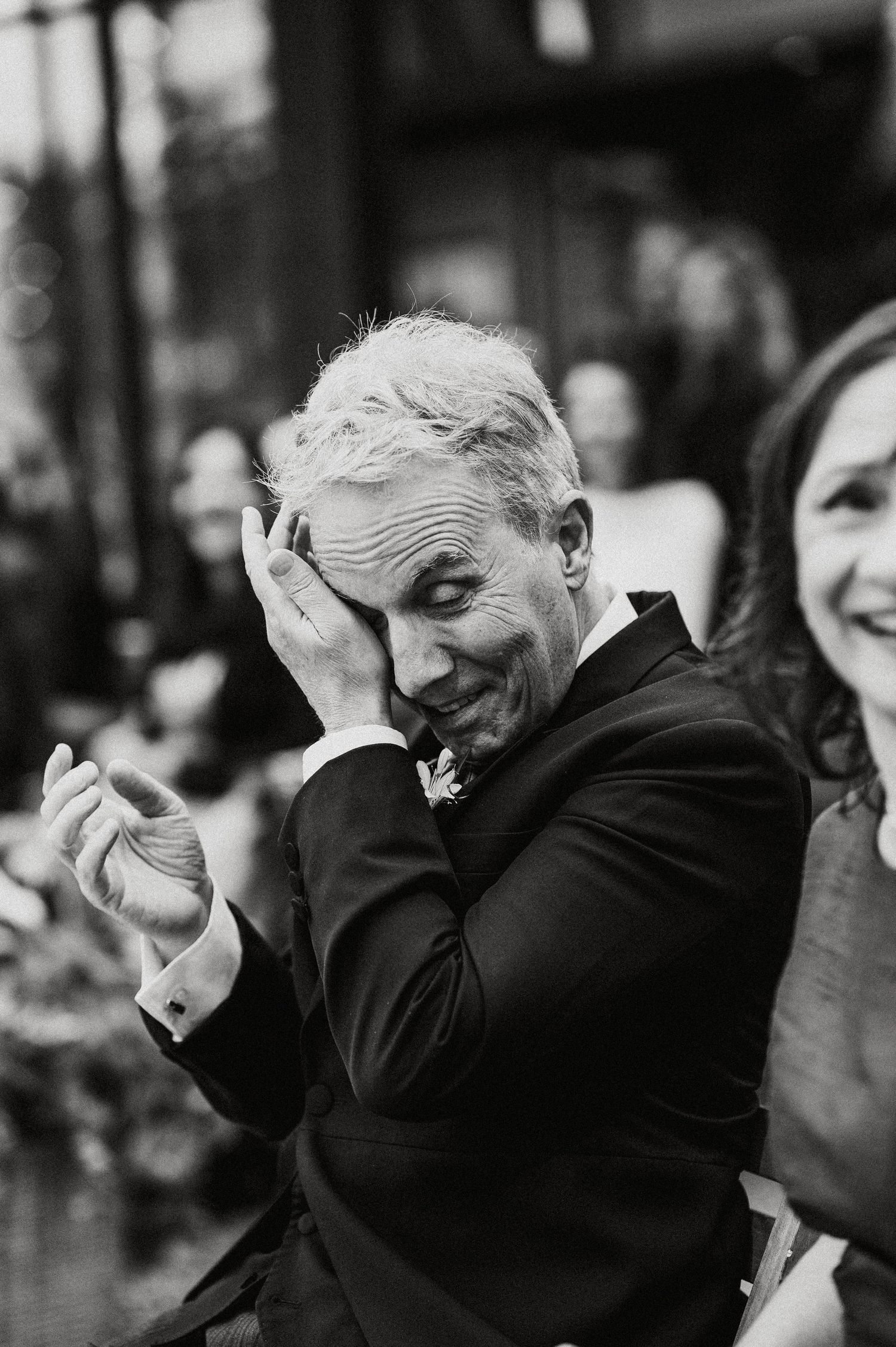 Black and white photo showing three sequential moments of someone laughing heartily with their head tilted back.