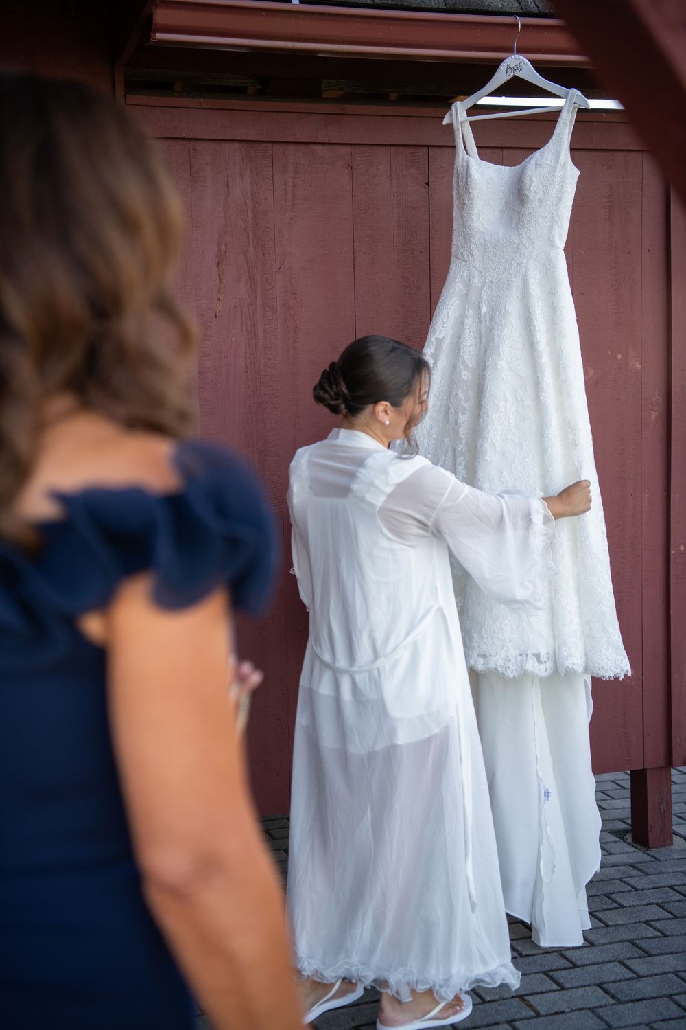 Wedding dress preparations showing white garments being arranged outdoors.