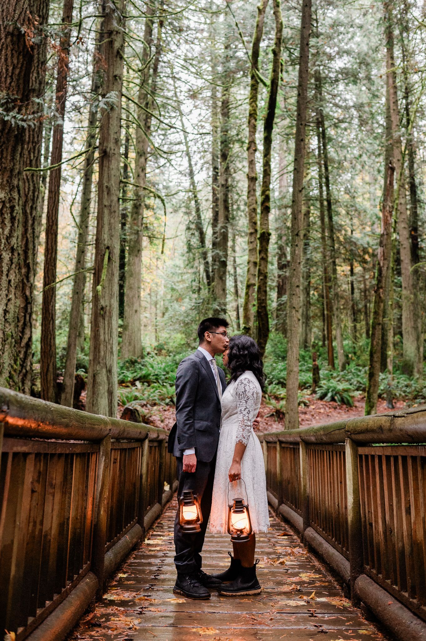 A bride and groom shares intimate moments on a wooden bridge through the Grand Forest West on Bainbridge Island