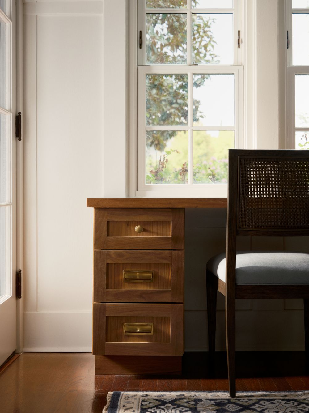 Cozy reading nook with wooden desk and window light — interior detail captured by Khoi Ly Photography.
