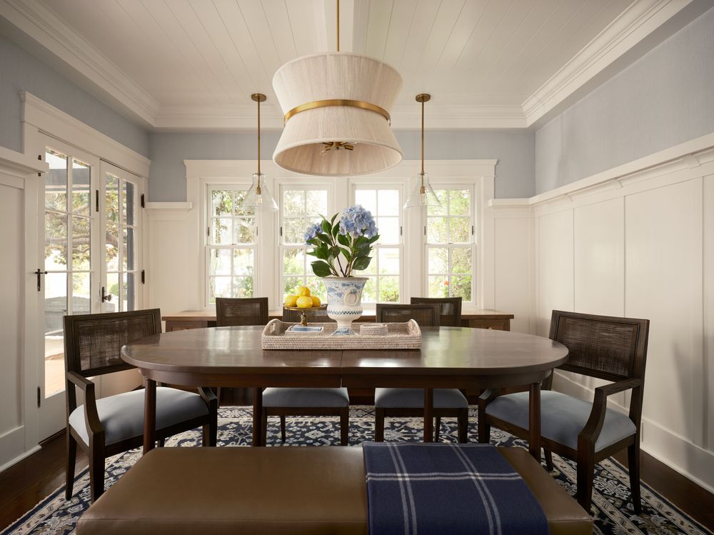 Elegant dining room with natural light, wainscoting walls, and modern chandelier — photographed by Khoi Ly in a classic residential home.