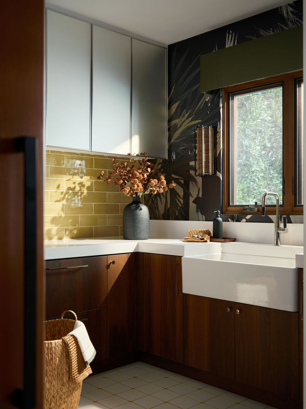Contemporary bathroom with dark wood cabinetry, dual sinks, and a warm gold-toned backsplash — Alta La Jolla project by Khoi Ly Photography.