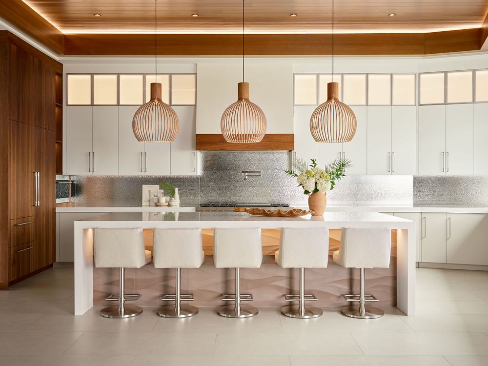 Sophisticated kitchen with large island, pendant lights, and warm wood tones — luxury interior photography by Khoi Ly in La Jolla.