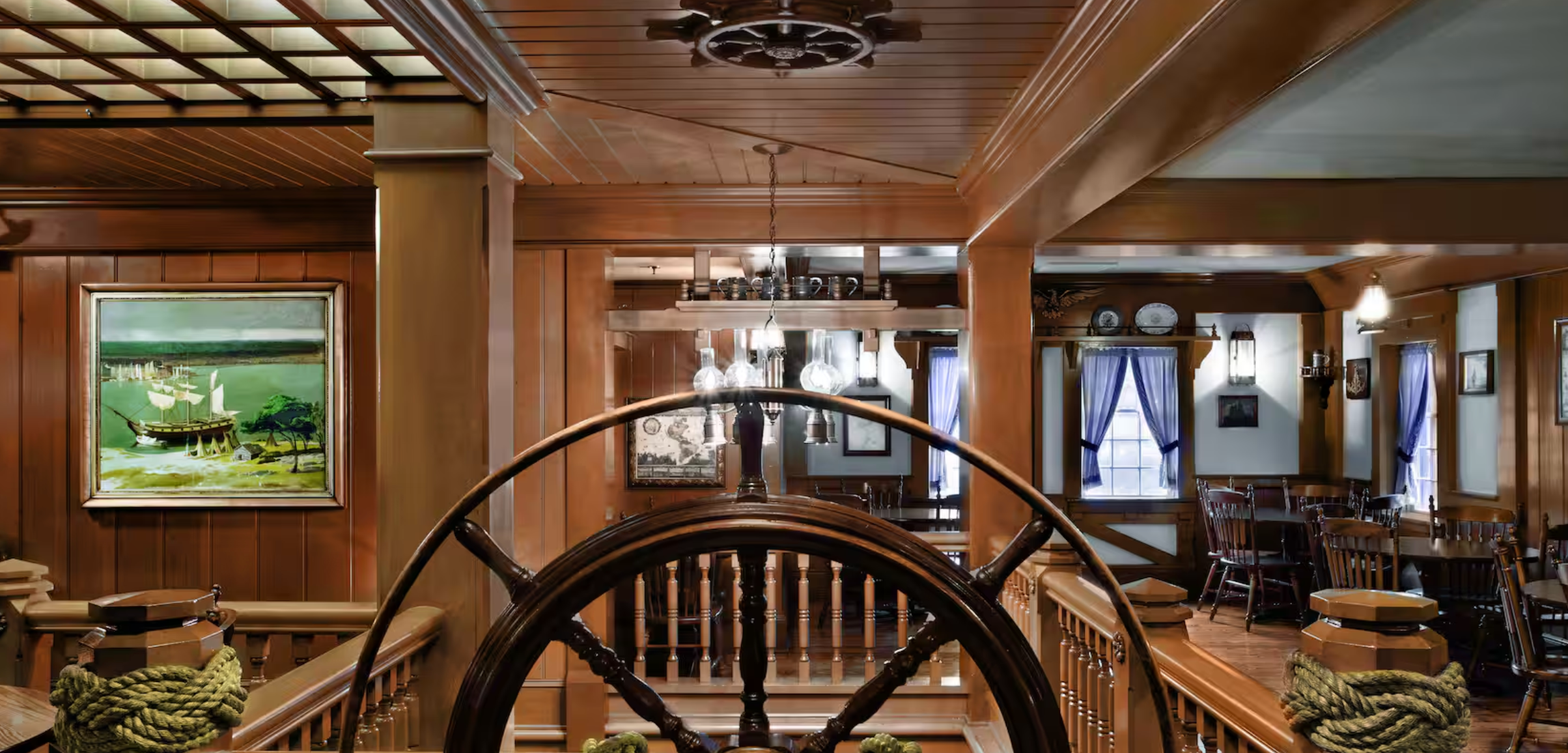 Rustic wooden beam ceiling and nautical lighting fixtures create warmth in a luxurious lodge interior.