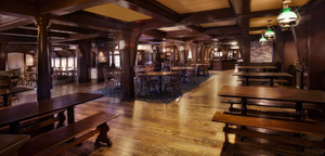 A rustic pub interior with dark wood beams, long wooden benches, and pendant lighting illuminating a polished hardwood floor.