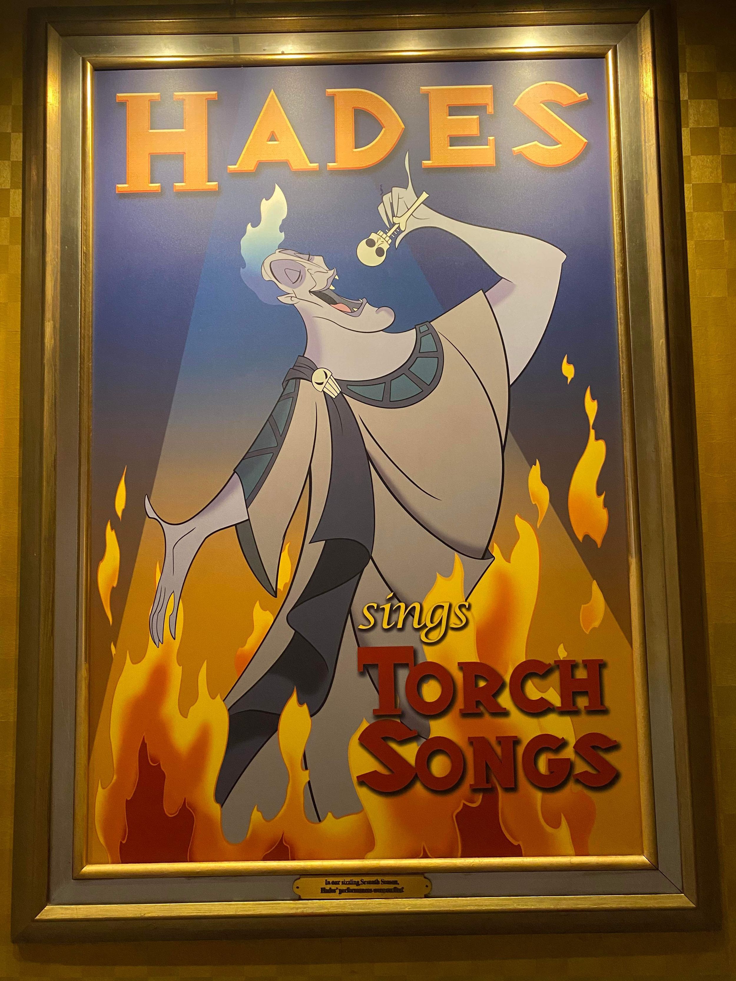 A vintage-style theater poster shows Hades sings Torch Songs with a figure dramatically posed against flames in the background.